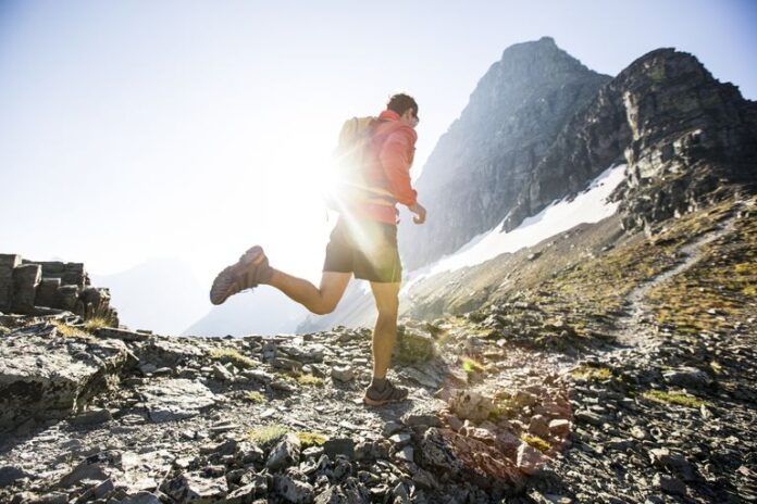 man-running-in-glacier-park-royalty-free-image-1613514223_